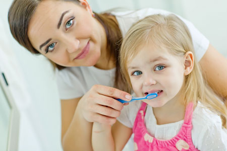 Mom and Daughter brushing their teeth - Pediatric Dentists - Pediatric Dentist in Ridgecrest, CA